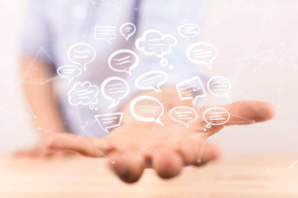 Sprechblasen über eine Hand Über einer Hand schweben Sprechblasen